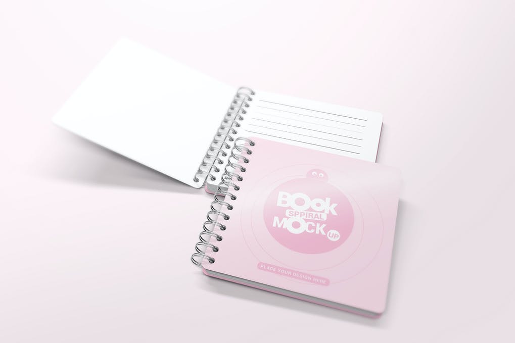A blank spiral notebook mockup with a white cover lying open on a soft pink background, showcasing the potential for customization and branding opportunities.