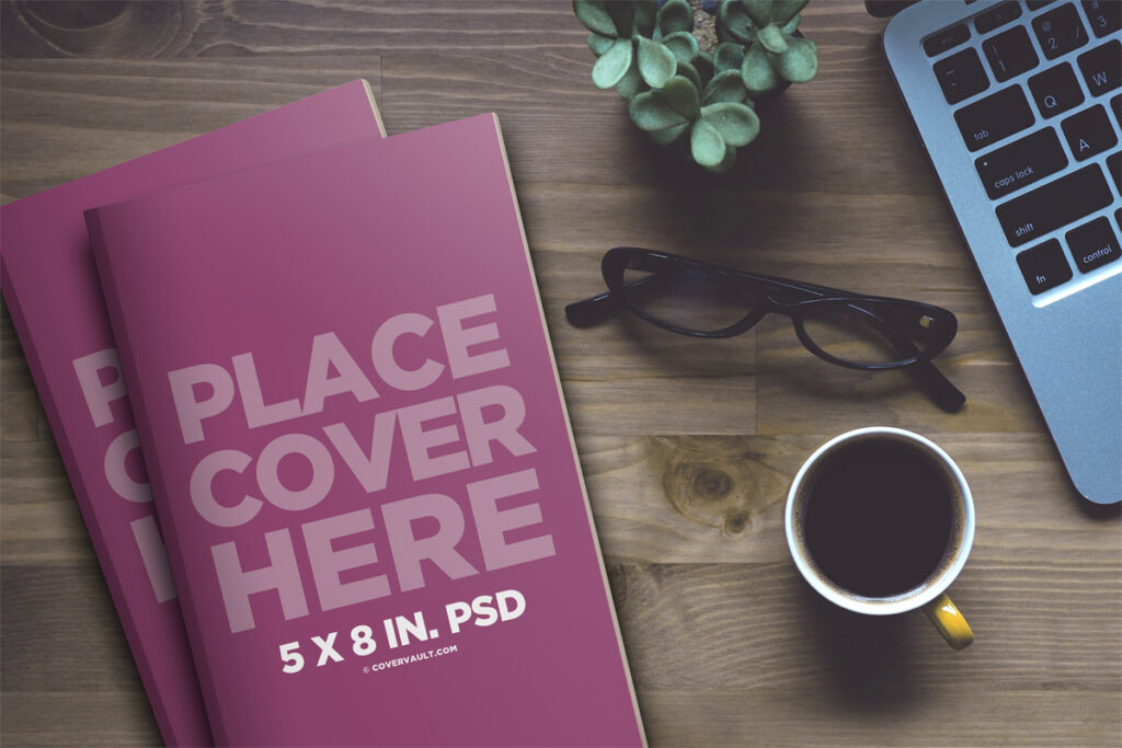 Paperback Coffee Table Book Mockup with Laptop
