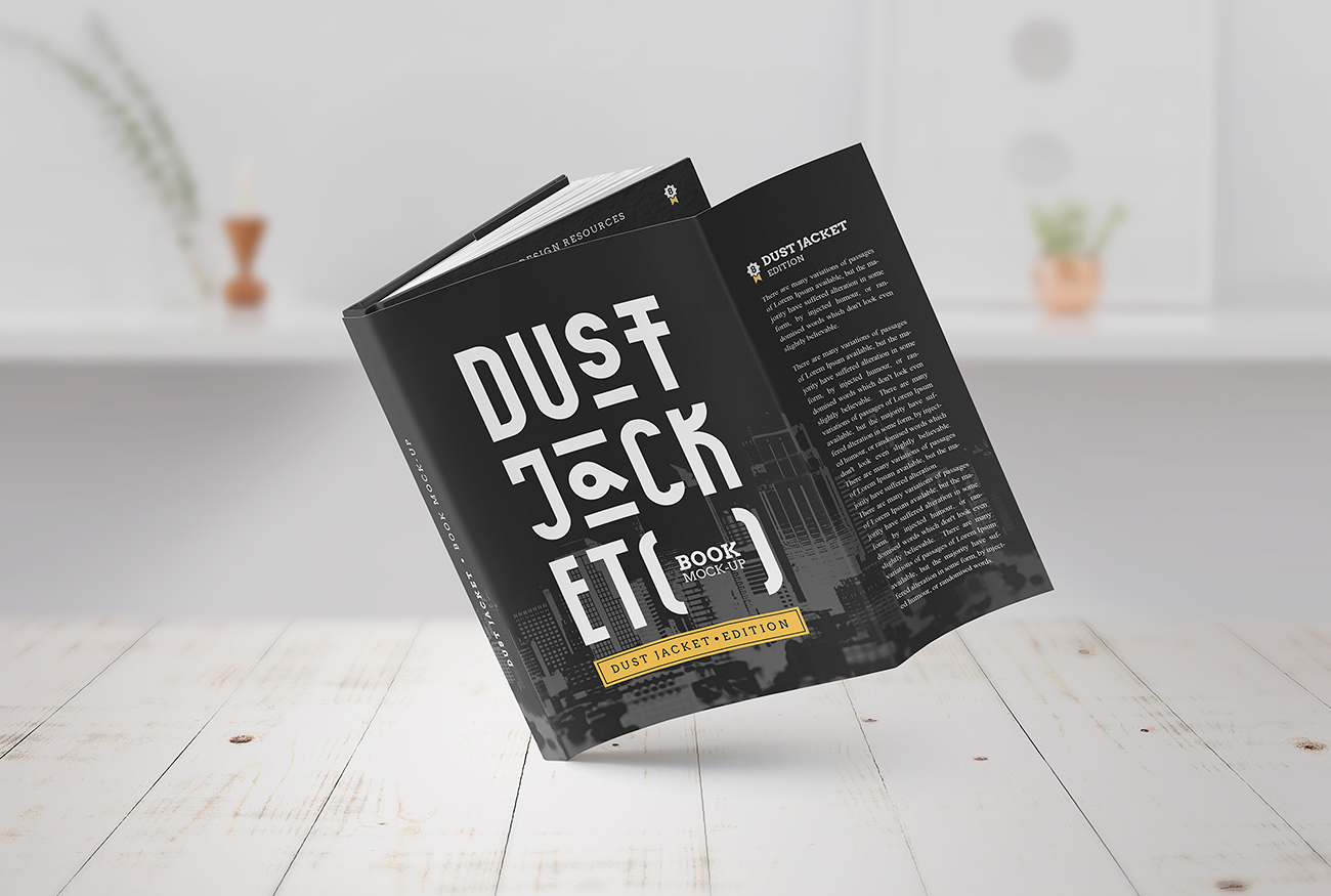 A hardcover book titled "dust jacket" stands open on a white surface against a blurred interior background, giving a sense of a modern, airy space for reading and relaxation. This setup serves as