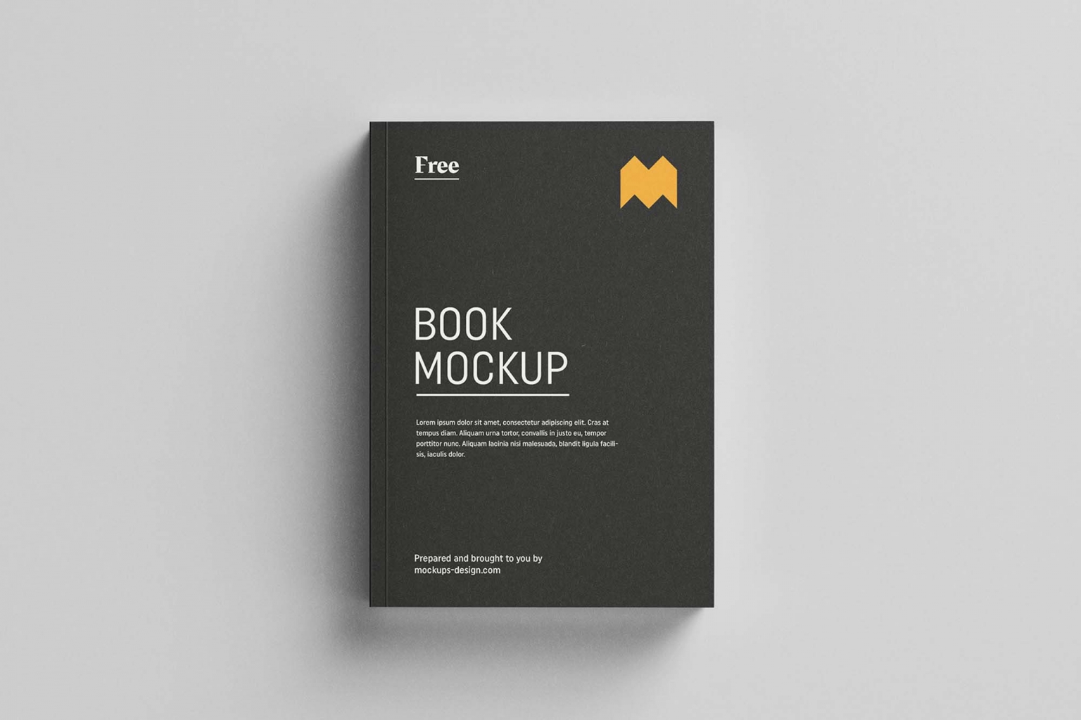 A sleek black softcover book mockup with the title "book mockup" in bold white letters and a small, orange crown-like logo at the top right corner, laid on a plain white background