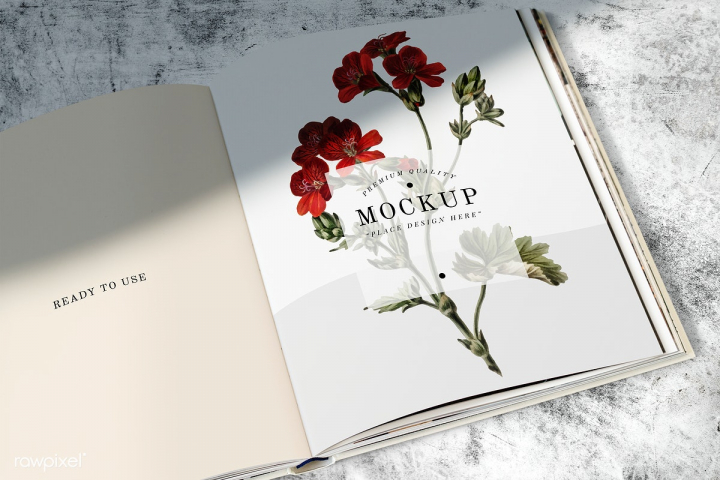 An open book with a floral mockup design on a textured background in PSD format.
