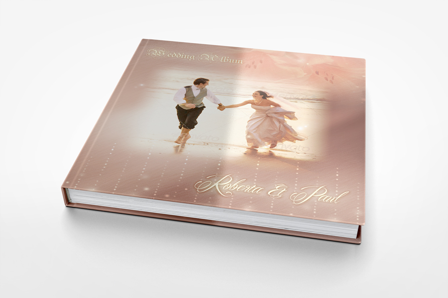 A photobook mockup cover featuring a romantic image of a couple dancing amidst a dreamy backdrop, with their names 'roberta & paul' elegantly inscribed below.