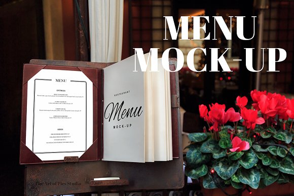 An elegant menu book mockup presented on a table with decorative flowers in the backdrop, exemplifying a sophisticated dining atmosphere.