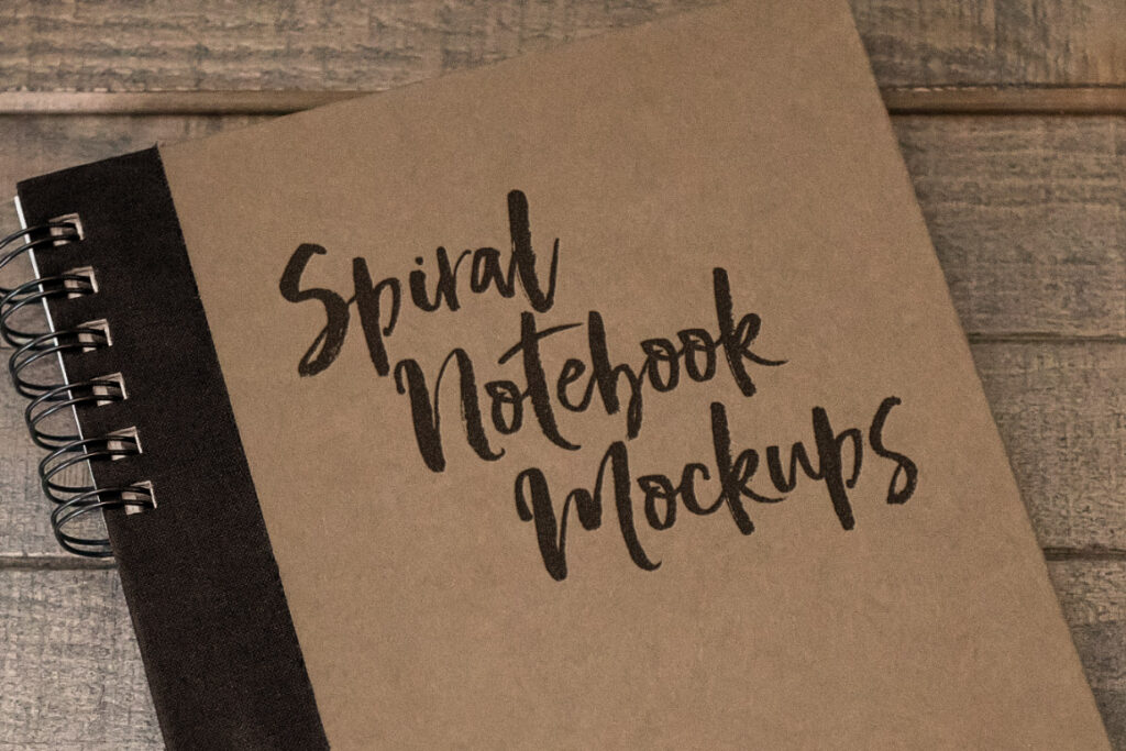 Spiral Notebook with a Wood Background Mockup