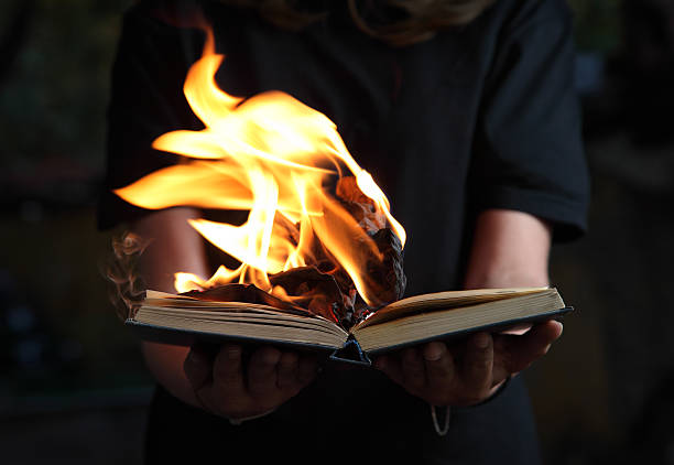 Book on Fire in Woman's Hands