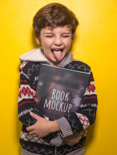 Lindo chico sosteniendo un libro contra su pecho