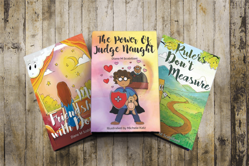 A trio of colorful children's books with imaginative titles and illustrations displayed on a wooden surface.